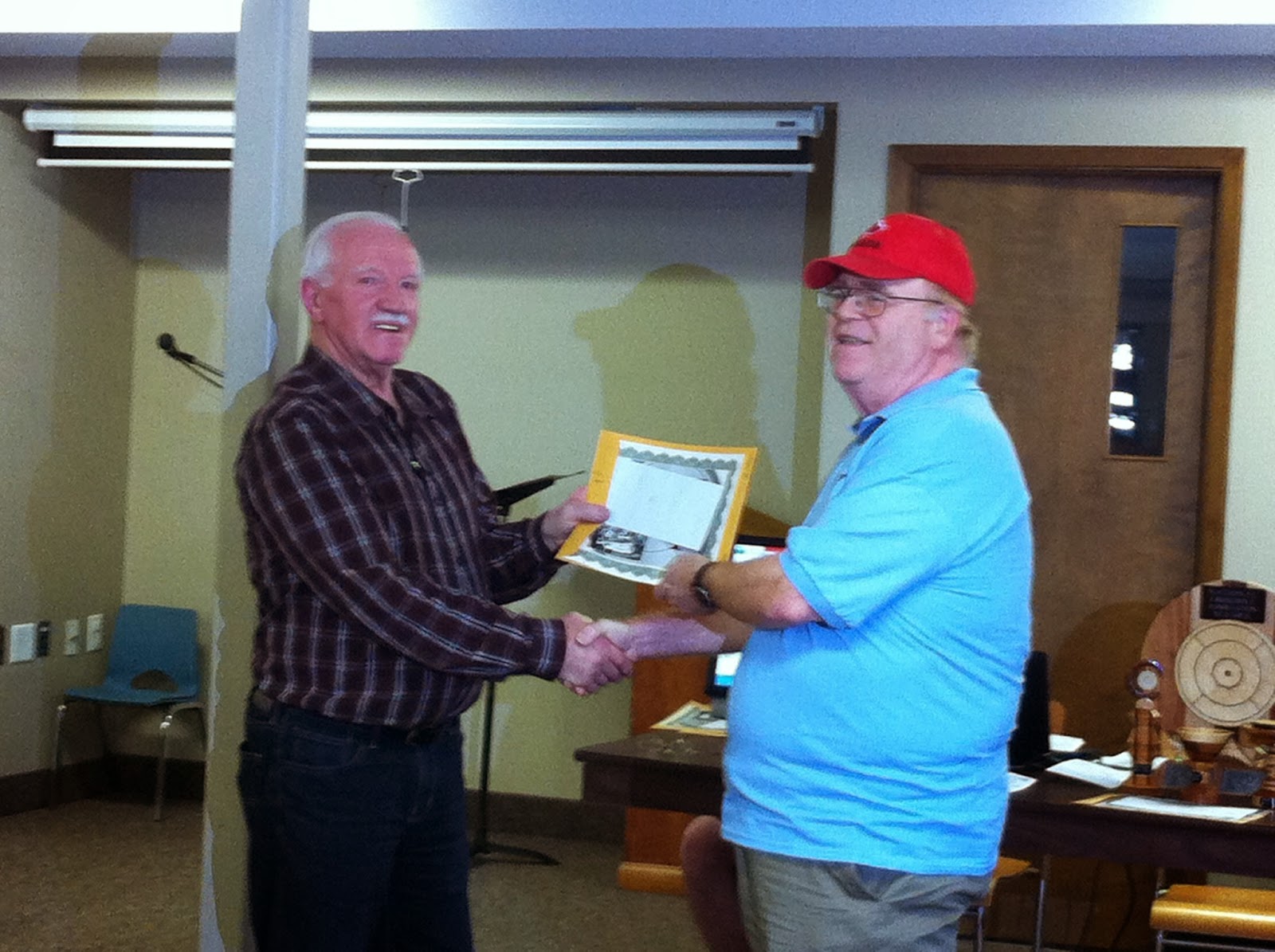 Pool B winner, Brian Simpson (right) accepting from St. Jacobs Club organizer, Howard Martin.