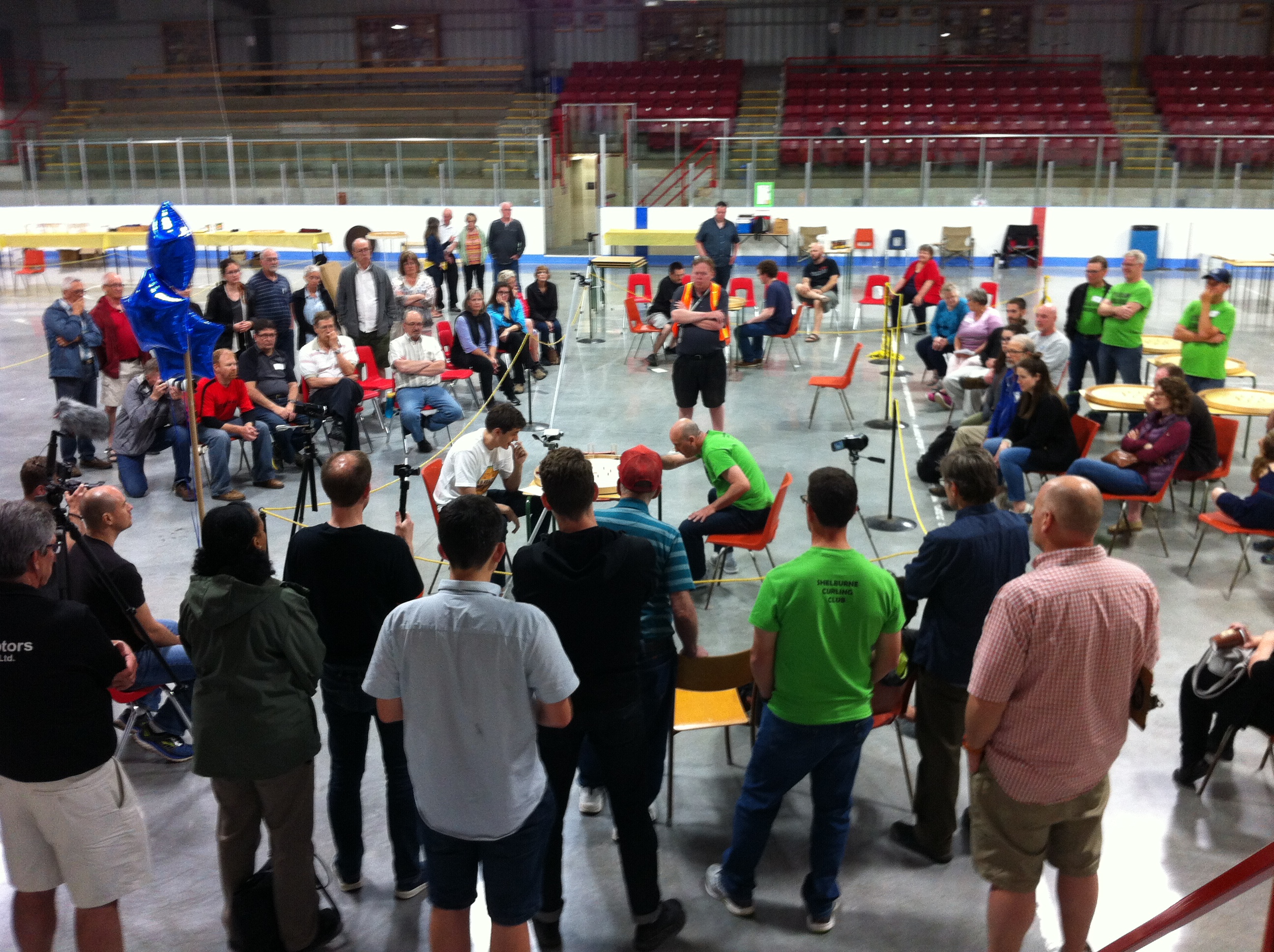 Spectators circle the board as the championship match is underway